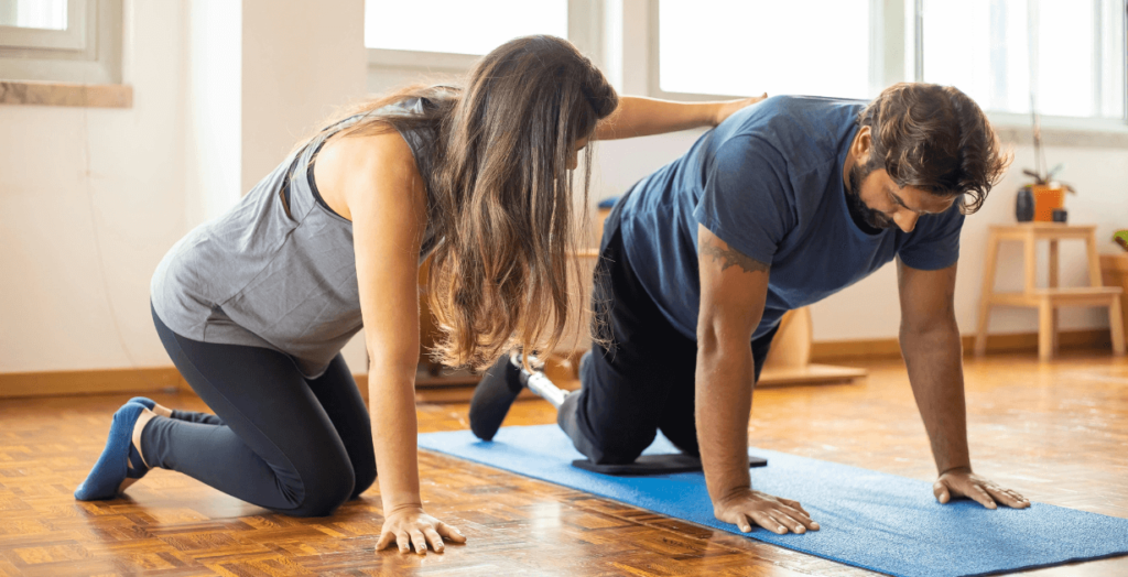 A female instructor guiding a male learner through a hands-on physical exercise, demonstrating a practical Micro Teach session.